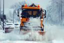 Stock image - a gritting lorry makes its way through the snow