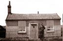 Ron Harris outside the first home he shared with his wife, Nina, at Shingle Street before the Second World War. Photo supplied for Life on the Edge by the Harris family.