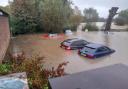 Cars were submerged in The Elms car park in Framlingham during Storm Babet as homes and roads in the town were flooded