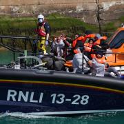Asylum seekers being brought into port by the RNLI  after their perilous small boat crossing via the Channel
