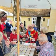 The 'Prince of Wales' enjoys a drink with customers at Swan Inn in Alderton