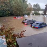 Cars were submerged in The Elms car park in Framlingham during Storm Babet as homes and roads in the town were flooded