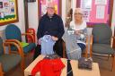 Reverend Richard Henderson and Fran Tuck warden of St Luke's Church with school uniform which has been washed and ironed ready for families who are in need.