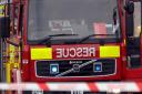 Fire crews have put out a fire that spread to three gardens because of some hot embers