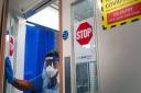 A member of staff wearing PPE walks through a ward for Covid patients at King's College Hospital, in south east London