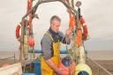 Emergency flood  plans have been put into action before the tidal  surge that is due to arrive on the east coast tonight, Thursday 5th December.
Aldeburgh fisherman Dean Fryer preparing for the surge.