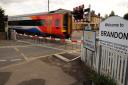 A train flashes past the new barriers at the level crossing on Bridge Street in Brandon. Photograph Simon Parker