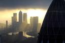 The 'Gherkin' and Canary Wharf at sunrise in the City of London. Picture: Stefan Rousseau/PA Wire