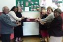Worshippers at Barkingside Methodist Church in Barkingside warm themselves up next to one of the new radiators.