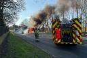 Firefighters tackling a car blaze in Hatfield Peverel were endangered when a motorist drove straight past the incident