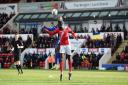 Sone Aluko jumps for the ball at Morecambe.