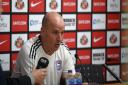 Paul Cook faces the media after the loss at Sunderland