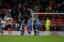 Ipswich players surround the referee after his awarded the home side a penalty at Sunderland