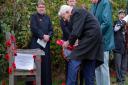 Veteran Percy King, aged 91, laying a wreath at the rededication service for Trimley St Mary's memorial bench