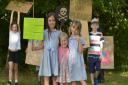 Families from Elmswell have taken part in the Great Big Green Week and are encouraging motorists to switch off their engines at the level crossing. Sophie, Indy and Sienna with their placards.