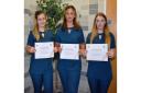 Students Tia Copland, Molly Hooper and Rhiannon Lamb with their certificates after training at Suffolk New College in how to spot signs of domestic abuse