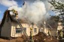 The fire has engulfed the thatched roof of The Ship Inn Picture: ARCHANT
