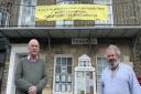 Southwold town councillors Simon Flunder and David Beavan with the banner which was temporarily put up at the start of the pandemic  Picture: JO FLUNDER
