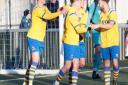 A FCSudbury players congratulate Callum Harrison after he had equalised from the penalty spot, with one of his two goals. Picture: PAUL VOLLER