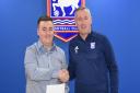 Ipswich Town manager Paul Lambert hands over his letter to the club's supporters to football reporter Andy Warren.