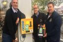 Jeremy Hagon from the Stanway Action Team, Craig Newnes franchisee of McDonalds Colchester and Martin Ford of Colchester Community First Responders stood next to the life saving machine. Picture: JEREMY HAGON