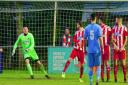 The Felixstowe defensive wall is worried as Connor Ingrams free kick goes just wide for Wroxham. Picture: STAN BASTON