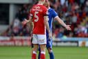 Joe Garner faces off with Angus MacDonald in a battle which continued throughout the second half at Barnsley. Picture: PAGEPIX LTD
