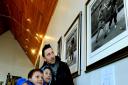 Craig Bacon and sons Cameron, 8, and Mackenzie, 10 look at the photographs of Bruce Lee.