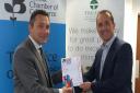 John Dugmore, chief executive of Suffolk Chamber of Commerce, presents the regional BCC Commitment to People Development trophy to Daemmon Reeve, chief executive of Treatt.