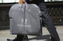 File photo dated 26/04/16 of a man carrying an Austin Reed bag, as the chain is to close 120 stores, resulting in the loss of approximately 1,000 jobs, administrators have said. PRESS ASSOCIATION Photo. Issue date: Tuesday May 31, 2016. See PA story CITY 