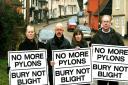 Pylon protesters, pictured in Kersey, Griff Rhys Jones and wife Jo with campaign members Frances Self, left, and Peter Eaton, right