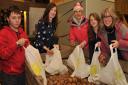 George Crooks, Leah, Andrea and Elise Golding and Liz Bennett assembling Christmas hampers