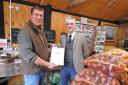 Chris Suckling receiving his community farming hero certificate from South Suffolk MP James Cartlidge