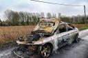A stolen BMW has been found burnt out and discarded down a country lane.