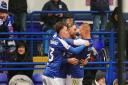 Nathan Broadhead (left) and Harry Clarke (right) celebrate with Wes Burns (centre) following his wonder strike against Coventry.
