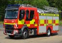 Five fire crews have been called to help a woman stuck in mud near East Bergholt.