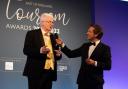 Alan Carr, winner of The East of England Tourism Awards 2021-2022's Outstanding Contribution to Tourism Award, on stage with host David Whiteley at last year's awards ceremony