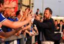 Ipswich Town CEO Mark Ashton celebrates with fans after the Blues' first win of the season at Lincoln City yesterday