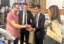 Chancellor Rishi Sunak is given a cookie during his visit by Ben Stamp during his visit to the Ipswich Microshops - watched by Tom Hunt and Economic Secretary to the Treasury Helen Whatley.