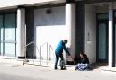 A passer by shares his food with a homeless man. Picture: SARAH LUCY BROWN