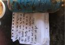 The distress note and blue aluminium bottle, apparently from a sailor stranded off the Suffolk coast, which was found on a Dutch beach