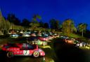 Classic vehicles illuminated in the Halls grounds