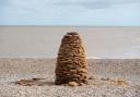 Henry Fletcher has created a coralline cairn on Thorpeness beach, created from rocks collected during stormy weather