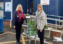 A Gatehouse food bank representative receiving the donation from Eve Hudson, a trainee solicitor at Ellisons.