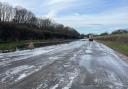 Half of the A143 in Bury St Edmunds is covered in ice while floodwater has been removed