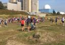 Runners gather for the start of the Sizewell parkrun, which passes the current Sizewell nuclear power stations