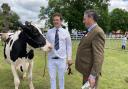 John Smith with his supreme inter-breed dairy champion cow and judge Barry Daw