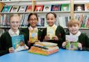 Pupils Millie, Seren, Isobel and Miller with some of the books donated by Barratt and David Wilson Homes  to St Margarets Primary School, Ipswich, for Children’s Mental Health Week.