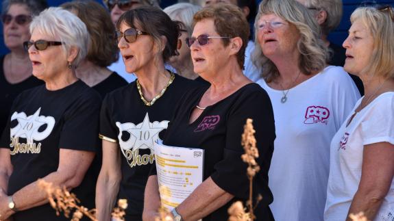 East Anglian Daily Times: Choir members singing on the seafront at Aldeburgh Carnival East Anglian Daily Times: Choir members singing on the seafront at Aldeburgh Carnival