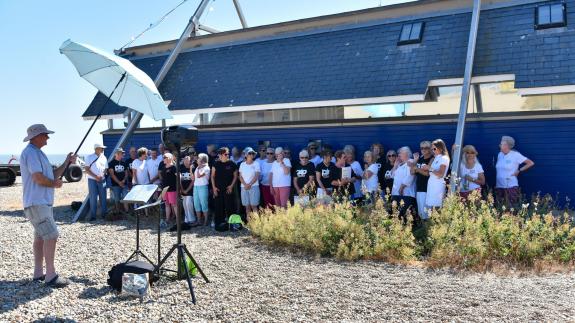 East Anglian Daily Times: A choir sings on the beach at Aldeburgh Carnival East Anglian Daily Times: A choir sings on the beach at Aldeburgh Carnival